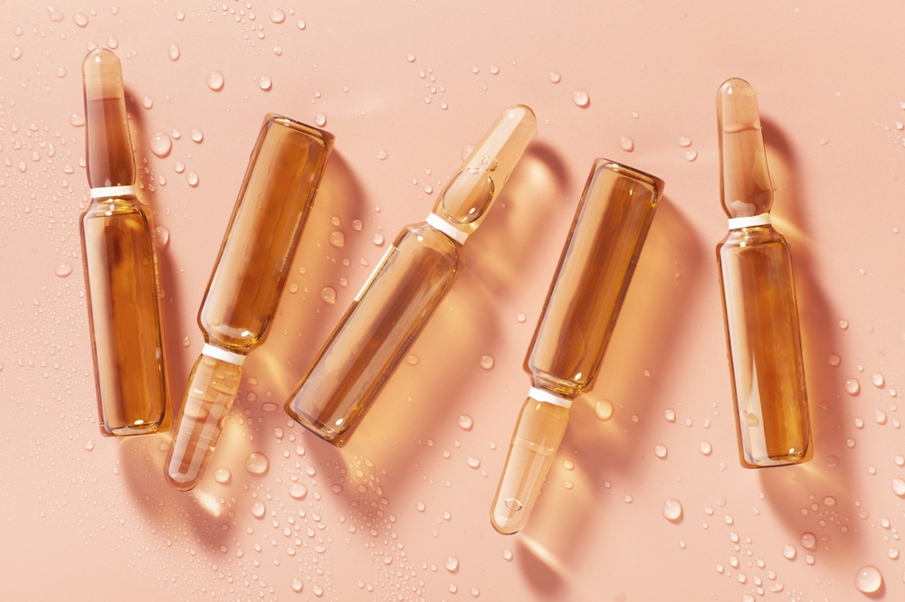 Cosmetic,Or,Medical,Orange,Ampoule,Contrast,Shadow,On,Wet,Pink